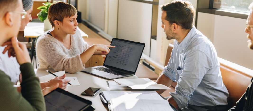 business group looking at laptop